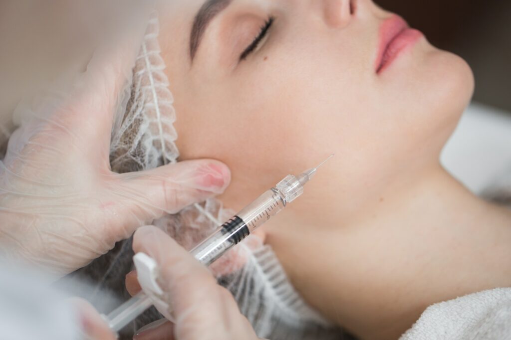 Cosmetic botox injection at the cosmetology medical center, close-up